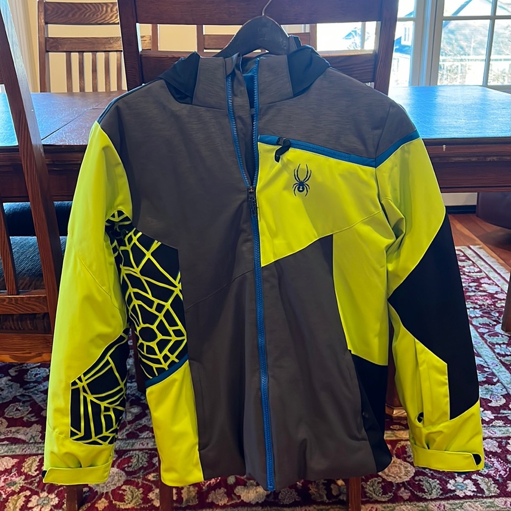 Spyder men’s ski. Colors: gray, black yellow, and a little blue.